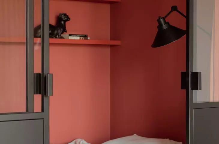 The walls of the bedroom were painted a strong brick shade