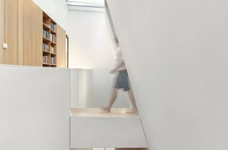 Running diagonally, the shear from the skylight to the first floor ceiling extends the natural lighting of the first floor