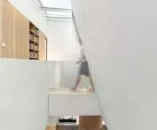 Running diagonally, the shear from the skylight to the first floor ceiling extends the natural lighting of the first floor