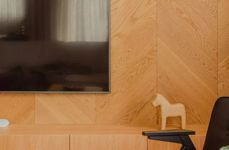 The wall in the living room is made of natural wood