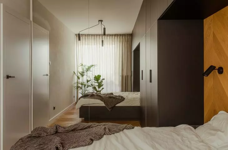 Inside the bedroom, a mirror enlarges the space