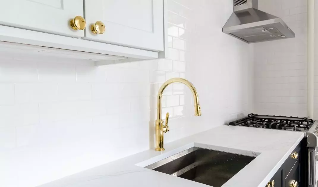 White tiles blend perfectly with gold elements