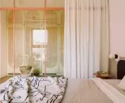 closet from the bedroom is separated by glazing in an aluminum frame