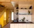 The interior is finished with wood, and a yellow cabinet at the entrance adds an accent