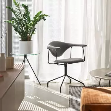 The small space of the living room is filled with furniture of modern forms