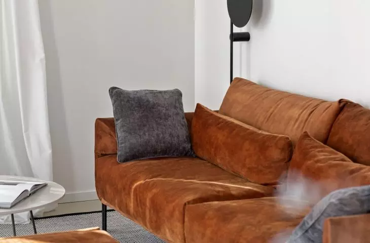 A strong color accent in the living room is the red sofa