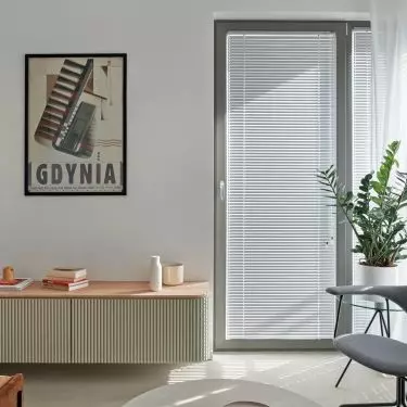 The living room is decorated with an elegant custom-made dresser