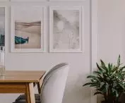 The living room wall is decorated with posters