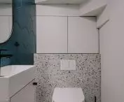There is a small toilet under the stairs