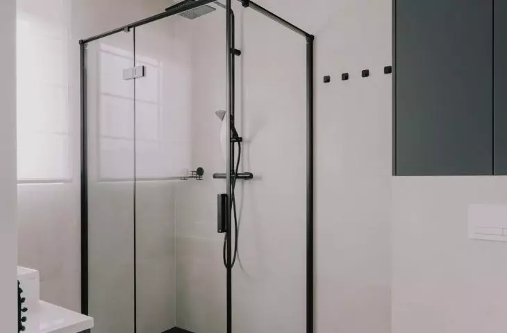 The bathroom is kept in gray and accents of black