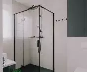 The bathroom is kept in gray and accents of black