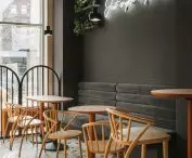 the cafe section is highlighted by a black wall with a neon sign