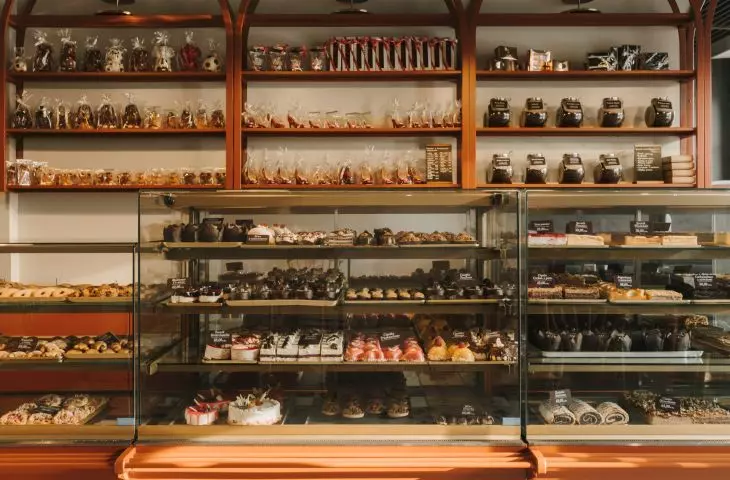 Behind the glazed counters, the architects placed openwork bookcases topped with arches