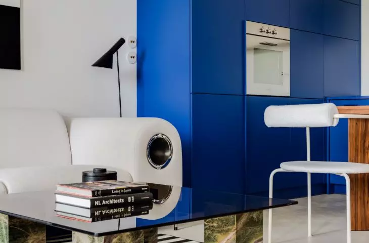The living room with kitchenette is full of simple, overlapping solids