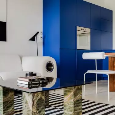The living room with kitchenette is full of simple, overlapping solids