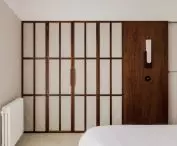 The dressing room is separated from the bedroom by a fabric door referring to Japanese shōji screens