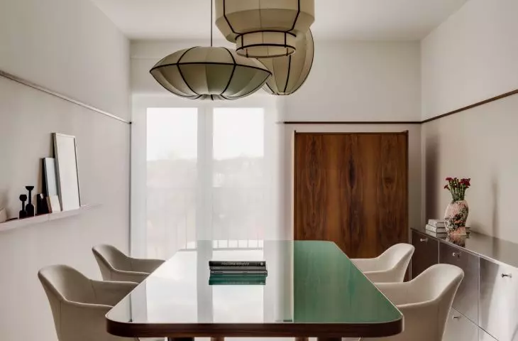 the central office area is occupied by a large table with a glass top with rounded corners
