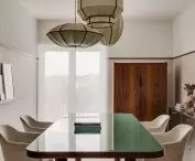 the central office area is occupied by a large table with a glass top with rounded corners