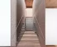 stairs made of steel mesh lead to the first floor