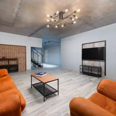 In a loft interior it is worth betting on a spreading chandelier 