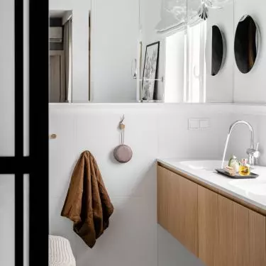 The bathroom is a juxtaposition of many materials and forms