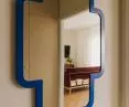 A distinctive feature is a mirror in a blue frame