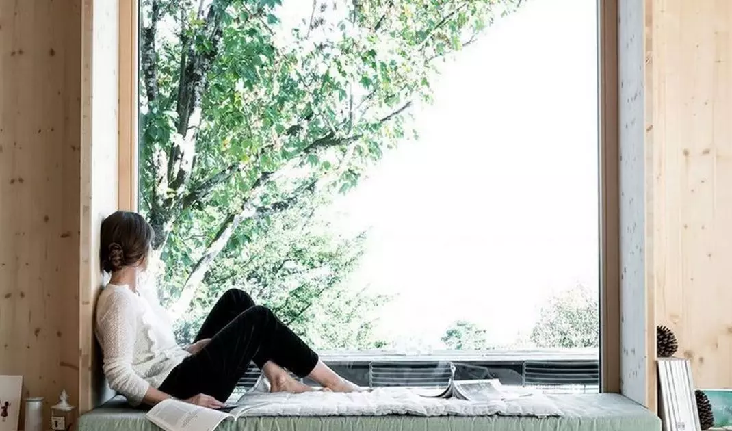 A wide windowsill can become a comfortable place to read