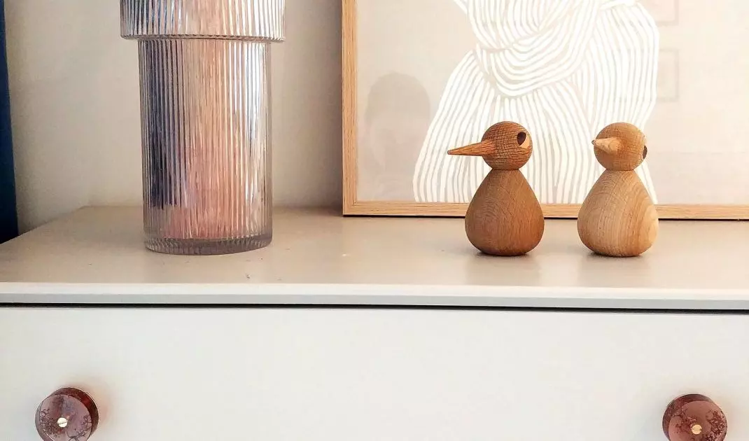 Colorful knobs will liven up a white dresser 