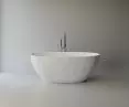 The geometric structure on the outer wall contrasts with its flowing, oval interior, which invites you to take a unique bath.