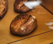 The bread is presented in a glass display case