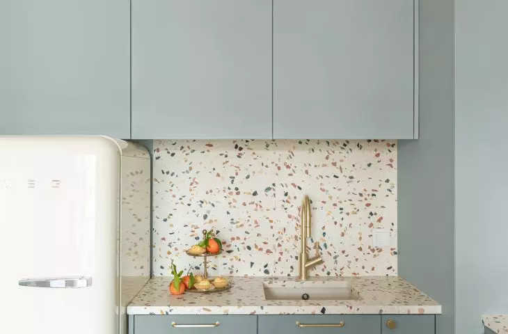 A Smeg refrigerator has been integrated into the kitchen space
