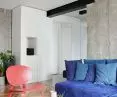 colorful accents in the living room - blue sofa and coral chair