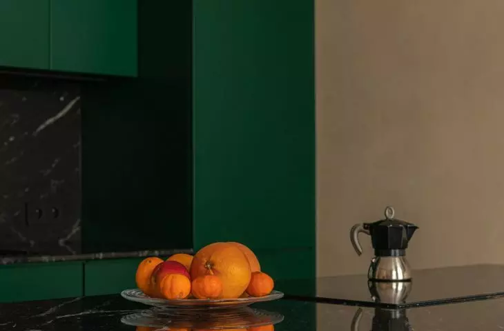 dark green dominates the kitchen