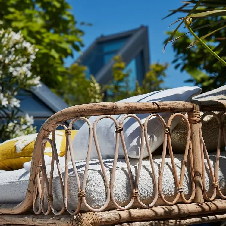 Bamboo daybeds that bring to mind colonial mansions in the Caribbean