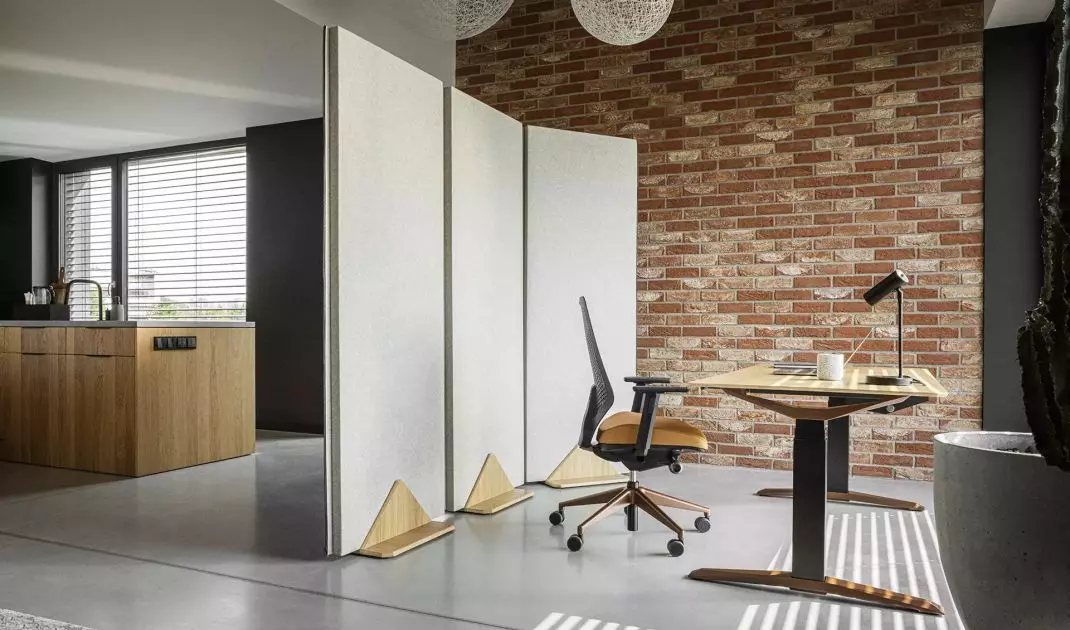 A screen separating the work area from the kitchen area