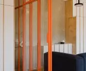 Between the living area and the bedroom, the architects introduced a glass wall