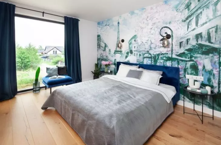 The attention in the bedroom is caught by a wall mural