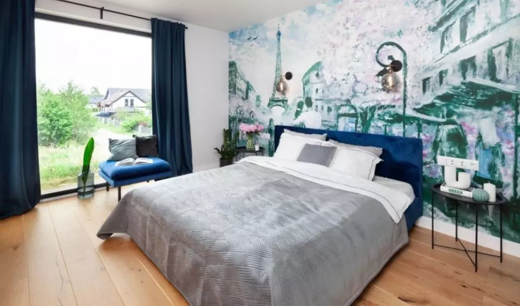 The attention in the bedroom is caught by a wall mural