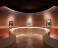 The architects opted for a splayed wall covered with copper panels and a ribbon-like curved plywood balustrade