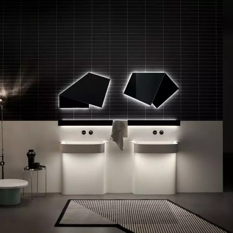 The sculptural shape of the washbasin is accentuated by ambient LED lighting