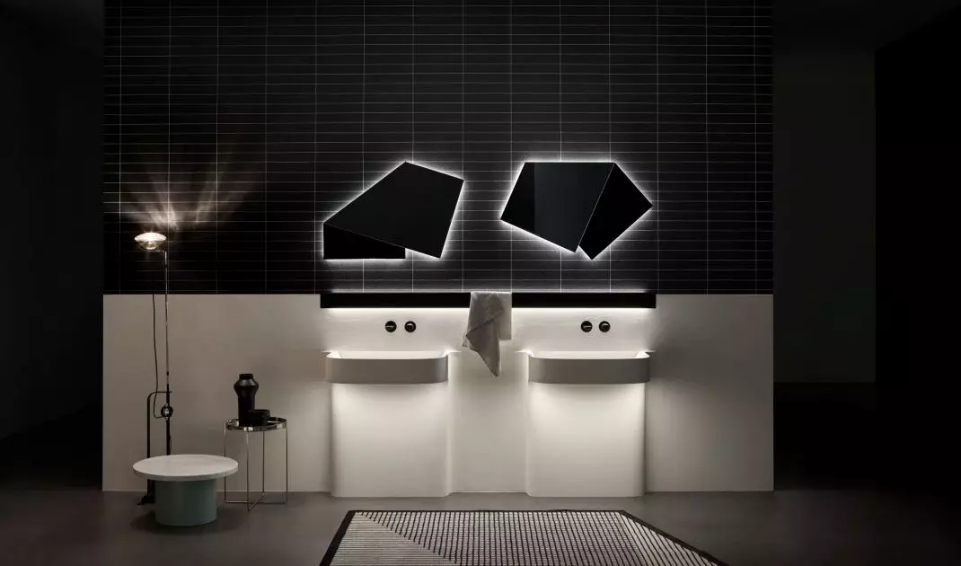 The sculptural shape of the washbasin is accentuated by ambient LED lighting