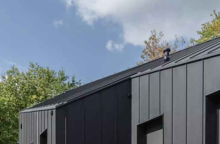 The facade was made of tan boards and sheet metal 