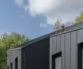 The facade was made of tan boards and sheet metal 