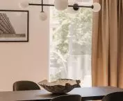 The table is decorated with a ceramic bowl by Jacek Budzowski.