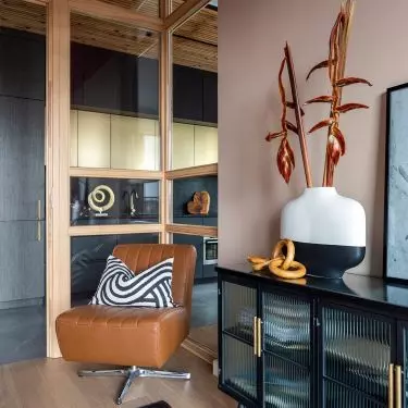The study is separated by a glass enclosure in a wooden frame