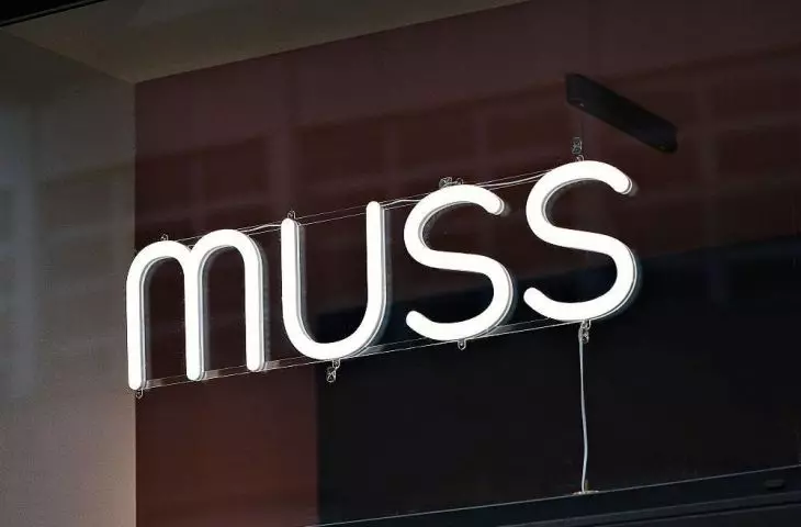 A neon sign with the logo of a Szczecin pastry shop