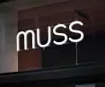 A neon sign with the logo of a Szczecin pastry shop