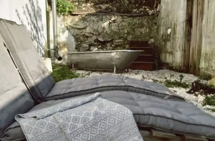 The original section of the wall with the front door (right) remains of the old house