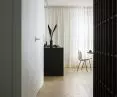 Black and white walls combine with natural wood flooring