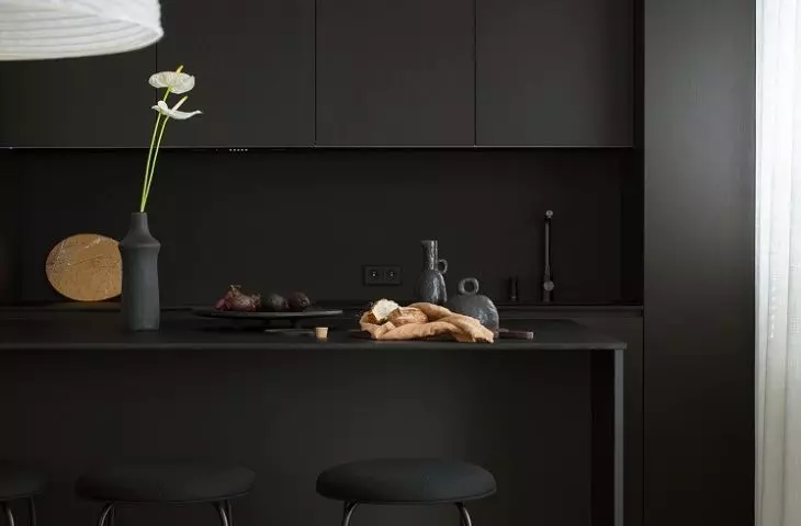 Black kitchenette and island with delicate countertop